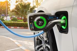 Electric vehicle changing on street parking with graphical user interface, Future EV car concept photo