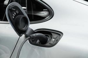 Electric car charging with power plug, Technology electric vehicle concept photo