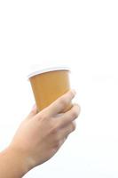 Hand and paper coffee sup, isolated, white background. photo