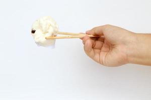 Hand, mini Chinese bun and chopsticks with white background. photo