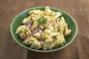 Healthy food cauliflower salad in bowl dish on wood background. photo