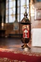 selective focus. A priest's censer hangs on an old wall in the Orthodox Church. Copper incense with burning coal inside. Service in the concept of the Orthodox Church. Adoration photo