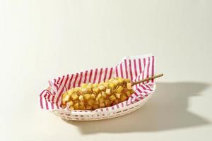 Delicious Crunchy Korean Style Chunky Potato Corn Dogs with Batter and Fried Potatoes. photo