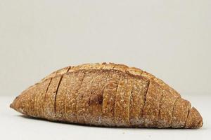 Loaf Whole Wheat Sourdough Bread on Cream Background photo