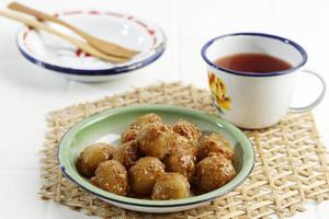 Cilok or Aci Dicolok, Traditional Street Food from West Java, Made from Tapioca or Aci Flour. Cilok is a Round Shaped Snack with a Chewy Texture, Served with Peanut Sauce photo