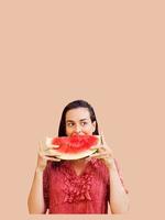 Cheerful woman holding a piece of sliced watermelon. Summer concept photo