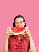 Cheerful woman holding a piece of sliced watermelon. Summer concept photo