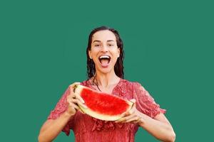 Cheerful woman holding a piece of sliced watermelon. Summer concept photo
