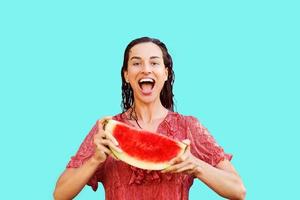 Cheerful woman holding a piece of sliced watermelon. Summer concept photo