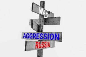 Wooden road sign with words war, russia, insane photo