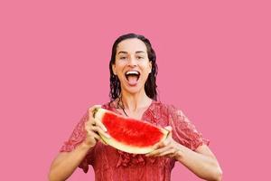 Cheerful woman holding a piece of sliced watermelon. Summer concept photo