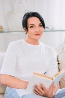 beautiful woman on the sofa reading book. Free time, education, self development concept. photo