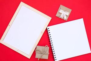 Note book on red background for Christmas concept. photo