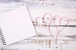 Paper hearts and notebooks photo