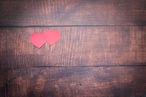 Paper heart on wooden floor photo