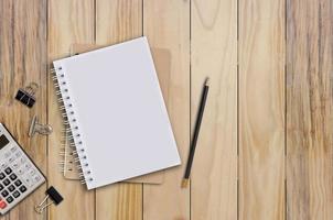 notebook and pencil Set on a brown wooden floor. photo