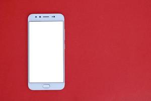 Mobile phone on a red background photo