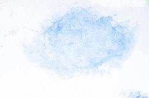 Blue watercolor on white paper photo