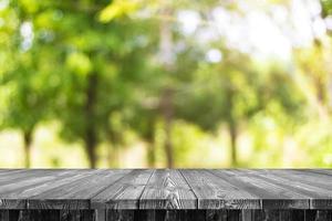 Wooden table with a green backdrop for your design photo