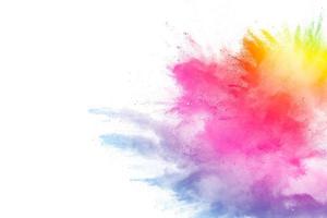 Freeze motion of colored powder explosions isolated on white background photo