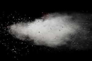 Launched white dust particles splashing. photo
