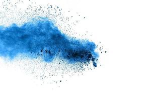 Bizarre forms of  blue powder explode cloud on background. Launched blue dust particles splash on white background. photo