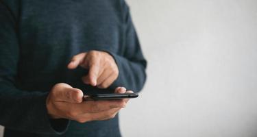 Man using cellphone for searching data and social media on internet. photo