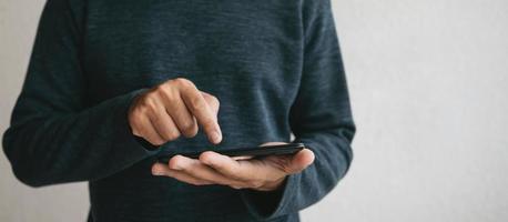 Man using cellphone for searching data and social media on internet. photo