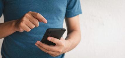 Man using cellphone for searching data and social media on internet. photo