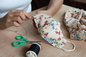 Making DIY masks at home sewing fabric mask handmade cotton protective equipment. photo