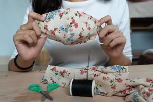 Making DIY masks at home sewing fabric mask handmade cotton protective equipment. photo