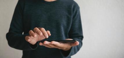 Man using cellphone for searching data and social media on internet. photo