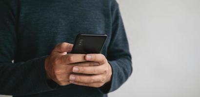 Man using cellphone for searching data and social media on internet. photo