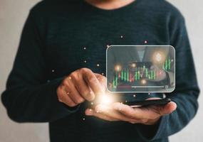 man using cellphone online for  watching video on internet  for trading strategy at corporate finance fund tutorial. technology business investment and education concept photo