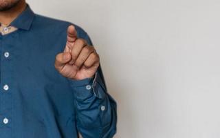 Young handsome man wearing light blue shirt with different behaviors at work photo