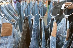 Old jeans trousers in a row photo