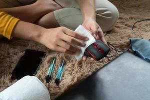 Cleaning the mouse  with a fiber cloth From dust and viruses other external factors. photo