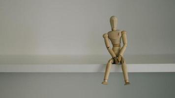 Wooden Man Lonely figure sitting alone photo