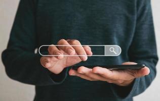 Close up hands holding smartphone. man working with smart phone and with blank search bar. Searching Browsing Internet Data Information Networking Concept photo
