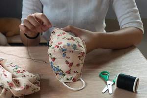 Making DIY masks at home sewing fabric mask handmade cotton protective equipment. photo