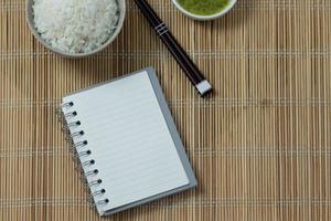 The white book of the menu placed on a wooden table photo