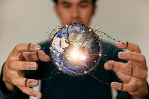 Man holding planet earth as destruction of the world, ecological and renewable energy world concept. Elements of this image furnished by NASA photo