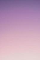 Abstract gradient sunrise in the sky with blue smooth blurred purple and orange natural background. photo