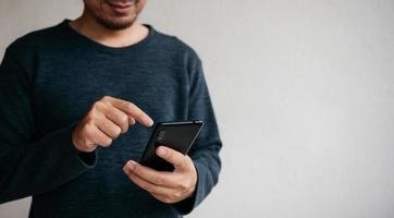 Man using cellphone for searching data and social media on internet. photo