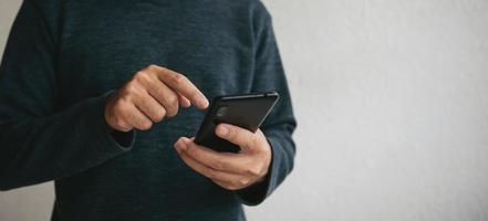 Man using cellphone for searching data and social media on internet. photo