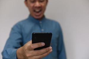 Young handsome man wearing light blue shirt with different behaviors at work photo