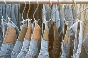 Old jeans trousers in a row photo