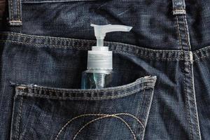 Anti-coronavirus spray. A man Carry it in the pant pocket photo
