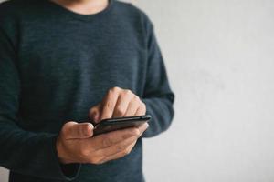 Man using cellphone for searching data and social media on internet. photo