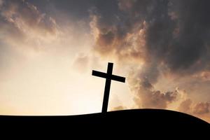 The cross on mountain sunset background photo